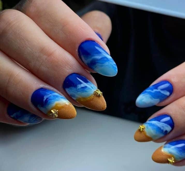 A truly breathtaking take on cruise nails, this mani uses two shades of blue and marbling techniques to recreate the mesmerizing beauty of ocean waves.