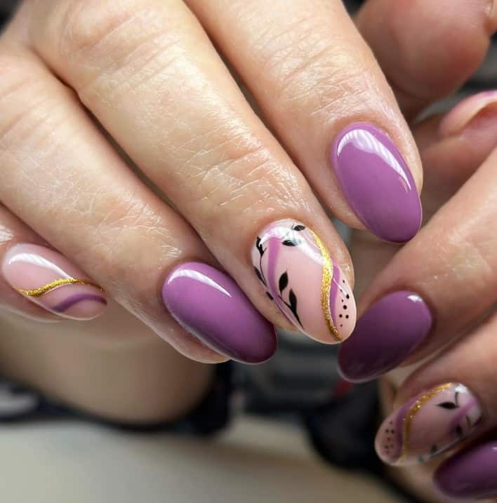 It features nude accent nails with majestic purple and glittery gold swirls, black dots, and delicate foliage art.