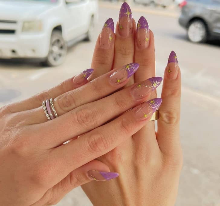 Reach for the stars with this mani, where purple French tips are topped with golden North Stars. 