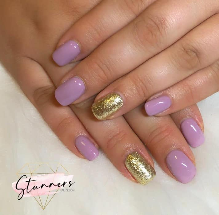 The epitome of understated elegance, these muted purple nails have their beauty amplified by a lone accent nail that dazzles in gold glitter.