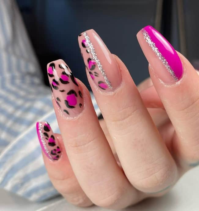 Sparkle and shine with this pink leopard nail design featuring nude pink bases and glittery lines that add a touch of glitz. 