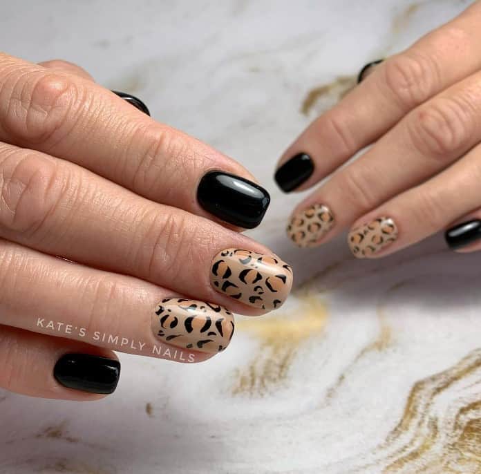 Sleek black nails are the perfect contrast for these natural-toned leopard spots, bringing a sophisticated edge to these trendy short squoval nails.