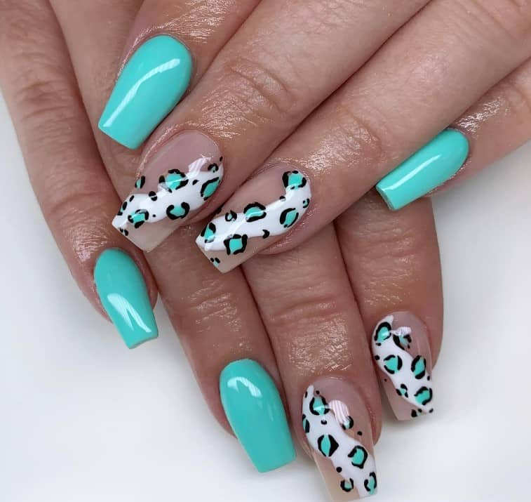 White swirls set the stage for the leopard prints, while other nails in solid blue keep the design company, offering a fun twist on the traditional animal print for a summery, chic look.